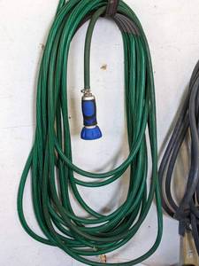 lot 99A image: Three Garden Hoses 1 - 100 ft. , 2 - 50 ft.