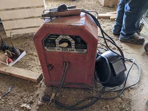 lot 25 image: Lincoln AC 225A Stick Welder Model AC-225-S - Includes Cables and Helmet - Works Good Per Seller