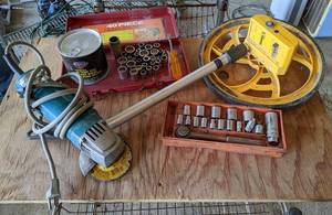 lot 21 image: Makita Angle Grinder, CH Hanson Measuring Wheel, New Can of Wheel Bearing Grease, Blackhawk Socket Wrench and Assorted Sockets