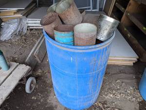 lot 191 image: Large Lot of Cut Out Coffee Cans for Putting around Plants - 55 Gallon Drum Full