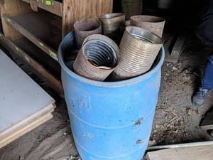 lot 192 image: Large Lot of Cut Out Coffee Cans for Putting around Plants - 55 Gallon Drum Full