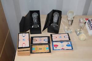 lot 142 image: (4) Basketball Trophies, (8) Basketball Court Hardwood Pieces with Court Pics