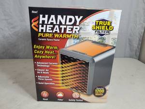 lot 69 image: New Handy Heater Pure Warmth Ceramic Space Heater