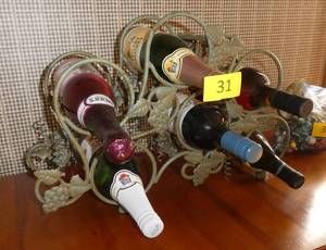 lot 31 image: A six place wine rack complete with bottles of grape juice