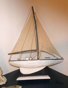 lot 69 image: A sea themed lot - sailing boat, boy fishing, a glass star fish filled with shells, a big glass shell, picture and photo frames
