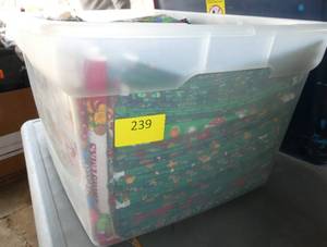 lot 239 image: Tote full of yard or 1.5 yard pieces of cotton fabric with christmas theme, I am guessing about 70 pieces