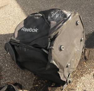 lot 305 image: Large Reebok bag with hunting and rain gear