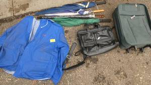 lot 323 image: A group of 4 umbrellas, rain coat, luggage bag and office computer bag