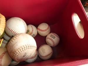 lot 290 image: Bucket of baseballs and softballs and 2 gloves