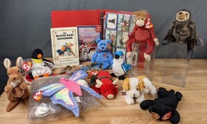 lot 97 image: Collection of (15) TY Beanie Babies, Handbook, & Trading Cards Blackie the Black Bear, Slowpoke the Sloth, Schweetheart the Red Monkey, & More - B
