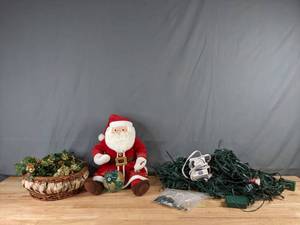 lot 296 image: Santa Claus Doll, Christmas Lights, and Holiday Pinecone Basket - Q