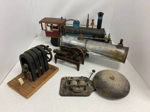 Group including handmade folk art heavy metal train, hand crank generator, steam toy and bell