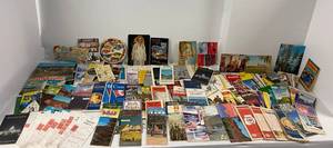 Large group of travel brochures, maps and postcards