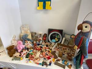 Large group of dolls, stuffed animals, wooden blocks and more.