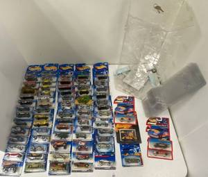 71 Hotwheels on cards, rotating display case and 6 hot wheel protective sleeves.