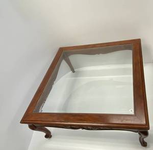 Solid wood coffee table with glass .