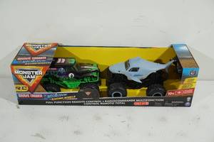lot 57 image: NEW Monster Jam Grave Digger and Megalodon Remote Control Trucks
