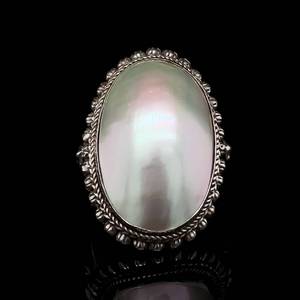 lot 90 image: Vintage Elegance Statement Large Mother of Pearl Oval Estate Ring with Detailed Ornate Bezel.
