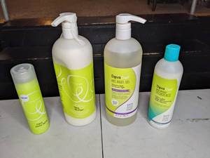 lot 161 image: Collection of 4 New DevaCurl Haircare Products Shine Spray, No-Poo Cleanser, Arc Angel Gel, No-Poo Decadence Cleanser