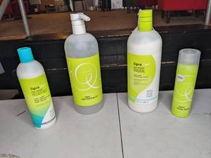 lot 162 image: Collection of 4 New DevaCurl Haircare Products Shine Spray, No-Poo Cleanser, Light Defining Gel, No-Poo Decadence Cleanser