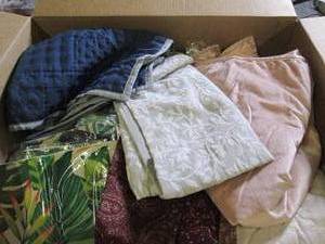 box of decorative pillow covers...