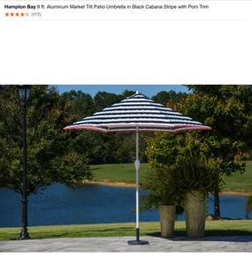 lot 55 image: Hampton Bay 9 ft. Aluminum Market Tilt Patio Umbrella in Black Cabana Stripe with Pom Trim. See Pictures