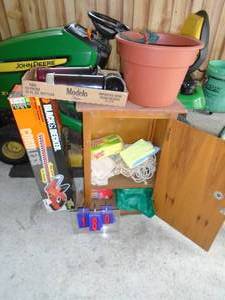 Wood cabinet with contents planter with sprinklers, Black & Decker trimmer with no battery or charger. As shown.