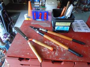 Pruner, lopper, bucket of gardent ools. As shown.