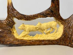 lot 5 image: Deer Antler Carving with Wolves Scene