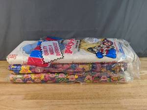 lot 111 image: Collection of Kids Themed Fabric Bolts Care Bear Applique, Colorful Fish, and Piggie People