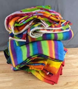 lot 326 image: Stack of Brightly Colored Patterned Fleece Fabric (Tie Dye, Stripes, Animals and More) - Z