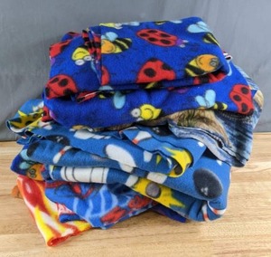lot 325 image: Stack of Fleece Fabric Scraps (Ladybugs, Ducks, Flames, Spider-Man and More) - Z