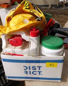 Box of garden chemicals, potting soil, plant food