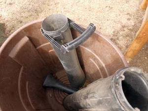 Garbage can full of leaf blower tubes and bags