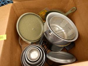 Box full of cookware including green color cast iron pan pot and pan