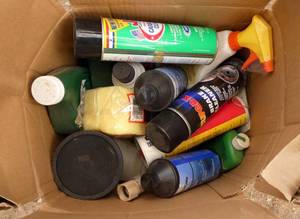 Box full of garage supplies - carb and brake cleaner, engine lube, armor all