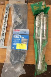 Bag of cable ties, lug wrench and corvette license plate cover