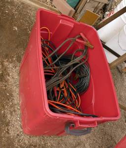 Tote full of wire, lights, jumper cables, extension cords