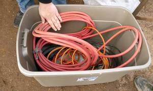Tote of air hose, extension cords, work light