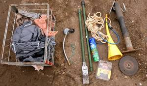 Trailer jack, funnel, chainsaw chain, shop rags, chisel, rope, funnel, etc