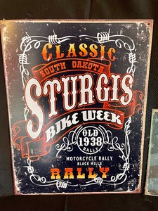 lot 27 image: 2 Sturgis Tin Signs