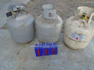 lot 111 image: Qty of 3 old style propane tanks with some contents. As shown.