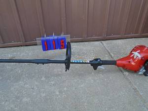 lot 115 image: Homelite straight shaft 2 cycle trimmer. Tested & works. Looks new. As shown.