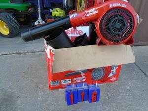 lot 116 image: Homelite 2 cycle blower. Looks new in box with tubes. tested , works..As shown.