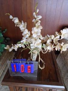 lot 106 image: Floral arrangement in brass holder with beads. As shown.