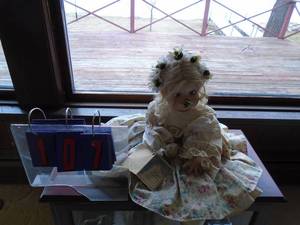 lot 107 image: Porcelin doll by  The doll maker Samantha # 414. Very nice detail. As shown.. Doll only. No display.