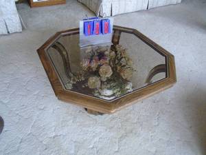 lot 108 image: Oak glass top octagon coffee end table with flower arrangement. As shown.
