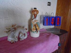 lot 148 image: Empty ozark ike,  hillbilly decanter. We found the box not shown & dragon figure. As shown.