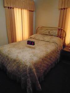 lot 174 image: Full size bed with brass headboard. Everything in picture included. As shown.