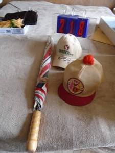 lot 218 image: Gander Mountain cap signed by Al Linder & other cap  umbrella. As shown.